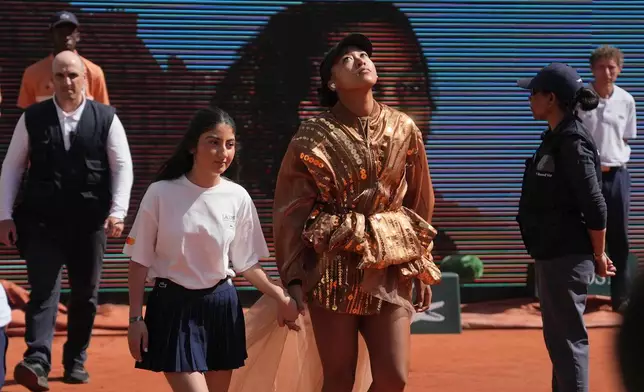 Naomi Osaka of Japan enters the court for the third round women's singles tennis match against Iva Jovic of the U.S. at the French Open tennis tournament in Paris, Saturday, May 30, 2026. (AP Photo/Thibault Camus)