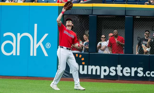 Cleveland Guardians' Chase DeLauter catches a fly ball by Washington Nationals' Jacob Young during the fourth inning of a baseball game, Wednesday, May 27, 2026, in Cleveland. (AP Photo/Phil Long)