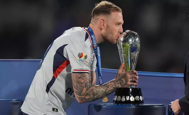 Cruz Azul's Rodolfo Rotondi kisses the trophy after winning the Mexican soccer league final against Pumas in Mexico City, Sunday, May 24, 2026. (AP Photo/Fernando Llano)