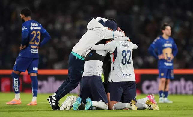 Cruz Azul players celebrate after beating Pumas during the Mexican soccer league second leg final match in Mexico City, Sunday, May 24, 2026. (AP Photo/Fernando Llano)