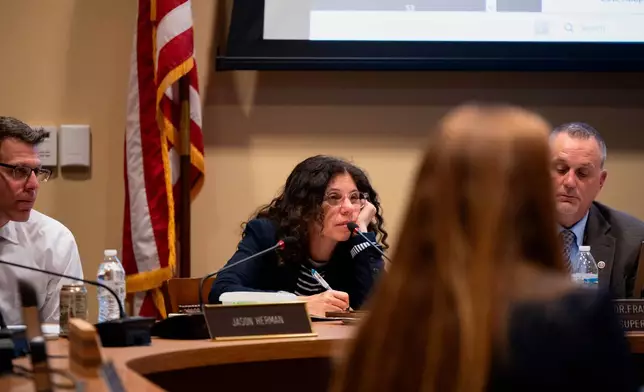 Members of the Lower Merion Board of School Directors speak with attendees at a school board meeting on Monday, May 11, 2026, in Ardmore, Pa. (AP Photo/Joe Lamberti)