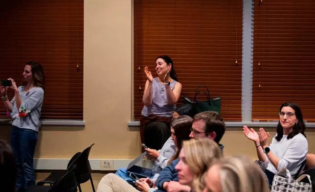 Attendees clap during a school board meeting at the Lower Merion School District Administration Building on Monday, May 11, 2026, in Ardmore, Pa. (AP Photo/Joe Lamberti)