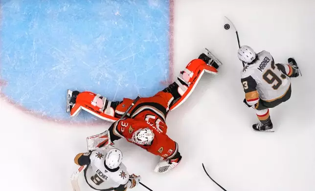 Vegas Golden Knights right wing Mitch Marner, right, scores on Anaheim Ducks goaltender Ville Husso, center, as center Jack Eichel watches during the second period in Game 3 of a second-round NHL hockey Stanley Cup playoff series Friday, May 8, 2026, in Anaheim, Calif. (AP Photo/Mark J. Terrill)
