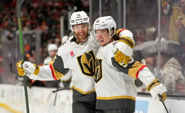 Vegas Golden Knights right wing Mitch Marner, right, celebrates his goal with defenseman Noah Hanifin during the second period in Game 3 of a second-round NHL hockey Stanley Cup playoff series against the Anaheim Ducks, Friday, May 8, 2026, in Anaheim, Calif. (AP Photo/Mark J. Terrill)