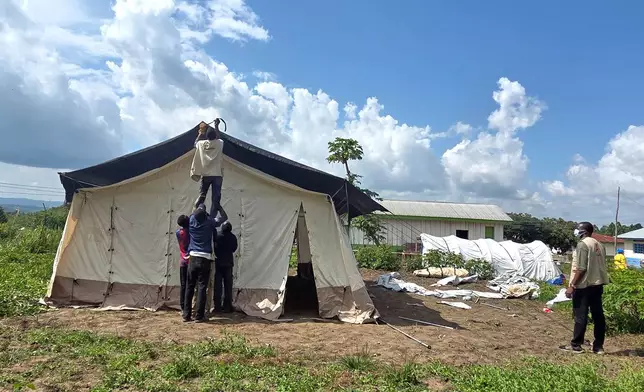 Aid workers set up an Ebola treatment center in Rwampara, Congo, Tuesday, May 19, 2026. (AP Photo/Dirole Lotsima Dieudonne) Corrects from Bunia to Rwampara