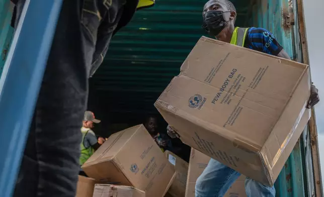 People offload a shipment of more than 15 tons of supplies donated by UNICEF as part of the response to the Ebola virus outbreak at Bunia National Airport in Bunia, Congo, Tuesday, May 19, 2026. (AP Photo/Moses Sawasawa)