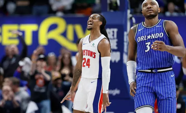 Detroit Pistons guard Daniss Jenkins (24) celebrates after sinking a three-point basket as Orlando Magic center Wendell Carter Jr., right, walks away during the fourth quarter in Game 7 of a first-round NBA basketball playoffs series Sunday, May 3, 2026, in Detroit. (AP Photo/Duane Burleson)