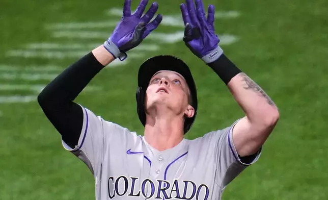 Colorado Rockies' TJ Rumfield celebrates as he crosses home plate after hitting a solo home run off Pittsburgh Pirates pitcher Brandon Bidois during the eighth inning of a baseball game in Pittsburgh, Wednesday, May 13, 2026. (AP Photo/Gene J. Puskar)