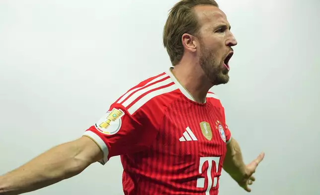 Bayern's Harry Kane celebrates after scoring during the German Cup final soccer match between VfB Stuttgart and Bayern Munich in Berlin, Germany, Saturday, May 23, 2026. (Michael Kappeler/dpa via AP)