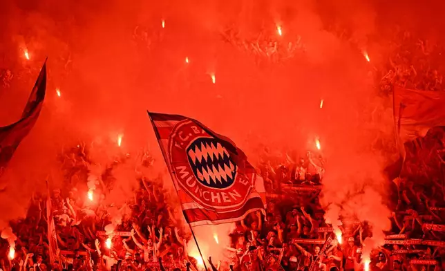 Bayern fans celebrate with pyrotechnics during the DFB Pokal, German Cup final soccer match between VfB Stuttgart and Bayern Munich in Berlin, Germany, Saturday, May 23, 2026. (Tom Weller/dpa via AP)