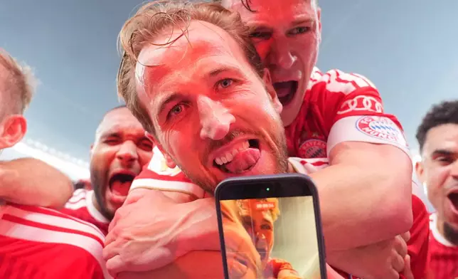 Bayern's Harry Kane, front celebrates with Joshua Kimmich after Kane scored his third goal during the DFB Pokal, German Cup final soccer match between VfB Stuttgart and Bayern Munich in Berlin, Germany, Saturday, May 23, 2026. (Michael Kappeler/dpa via AP)