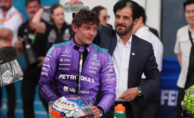 Mohammed Ben Sulayem President of the Federation Internationale de l'Automobile (FIA) pours water on the head of Mercedes driver Kimi Antonelli of Italy after Antonelli won the Miami Formula One Grand Prix auto race, Sunday, May 3, 2026, in Miami Gardens, Fla. (AP Photo/Rebecca Blackwell)
