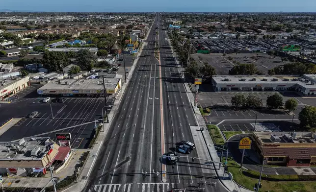 An aerial view shows a police checkpoint enforcing a road closure at the evacuation zone boundary in Anaheim, Calif., Monday, May 25, 2026. (AP Photo/Jae C. Hong)