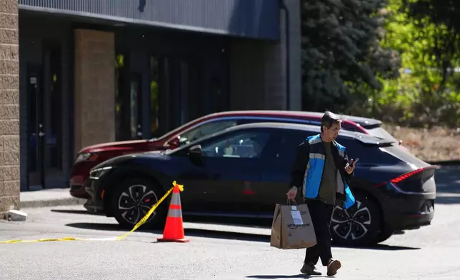 A driver picks up an order at an Amazon Now location, Monday, May 11, 2026, in Bellevue, Wash. (AP Photo/Lindsey Wasson)