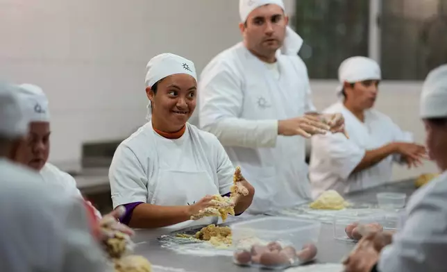 Camila Da Silva makes cakes at a nonprofit center that supports people with disabilities, in Moreno on the outskirts of Buenos Aires, Argentina, Tuesday, May 5, 2026. (AP Photo/Natacha Pisarenko)