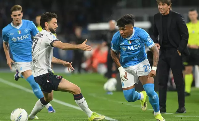Bologna's Joao Pedro, second left, challenges for the ball with Napoli's Alisson Santos during the Italian Serie A soccer match between Napoli and Bologna in Naples, Italy, Monday, May 11, 2026. (Alessandro Garofalo/LaPresse via AP)