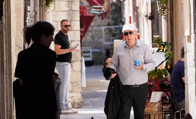 People make their way through old town of Dubrovnik, Croatia, Monday, April 27, 2026. (AP Photo/Darko Bandic)