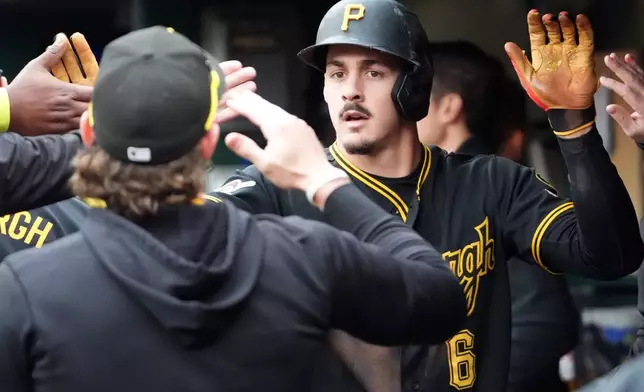 Pittsburgh Pirates' Konnor Griffin is greeted by his teammates after scoring on a single by Oneil Cruz against the Cincinnati Reds in the fourth inning of a baseball game in Pittsburgh, Saturday, May 2, 2026. (AP Photo/Tom E. Puskar)