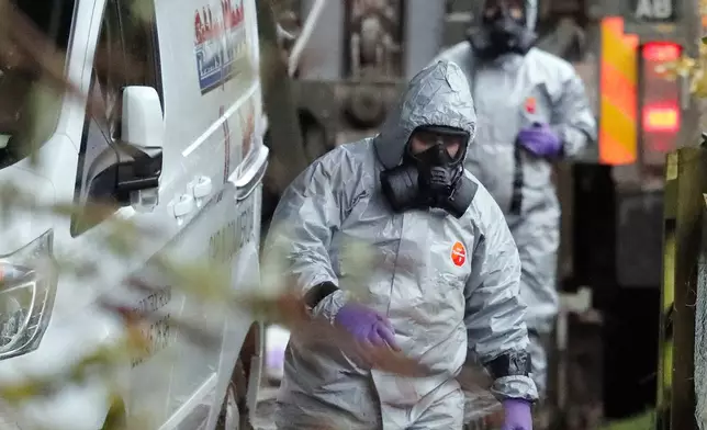 FILE - In this March 12, 2018, photo, personnel in protective gear work on a van in Winterslow, England, as investigations continue into the nerve-agent poisoning of Russian ex-spy Sergei Skripal and his daughter Yulia, in Salisbury, England. (AP Photo/Frank Augstein, File)