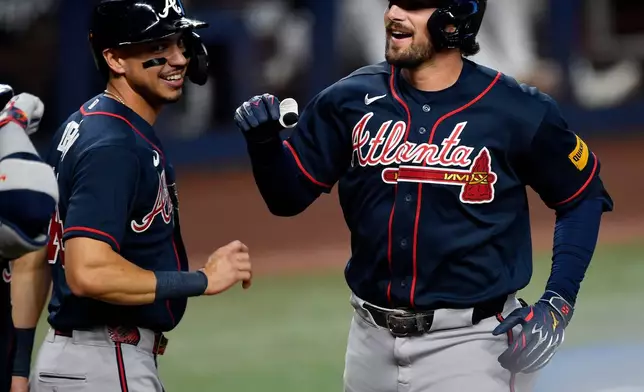 Atlanta Braves' Austin Riley, right, celebrates hitting a home run during the second inning of a baseball game, Wednesday, May 20, 2026, in Miami. (AP Photo/Michael Laughlin)