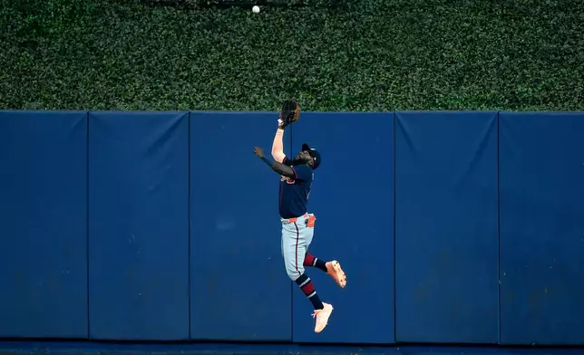 Atlanta Braves center fielder Michael Harris II catches a fly ball hit by Miami Marlins' Heriberto Hernández, not pictured, during the first inning of a baseball game, Wednesday, May 20, 2026, in Miami. (AP Photo/Michael Laughlin)