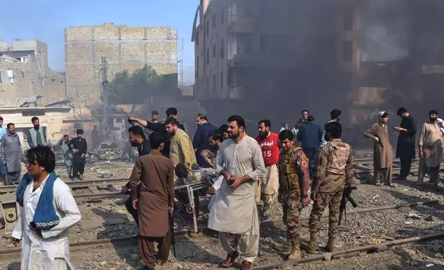Paramilitary soldiers and volunteers transport an injured victim at the site of bomb explosion, in Quetta, Pakistan, Sunday, May 24, 2026. (AP Photo/Arshad Butt)