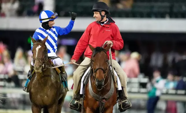 Jockey Jose L. Ortiz celebrates after riding Always a Runner to victory wins the 152nd running of the Kentucky Oaks horse race at Churchill Downs, Friday, May 1, 2026, in Louisville, Ky. (AP Photo/George Walker IV)