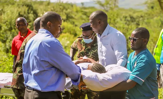 A victim of a fire is carried from a Kenyan Air Force aircraft at St. Joseph Hospital after a fire at Utumishi Girls School in the Gilgil area, central Kenya, Thursday, May 28, 2026. (AP Photo/Patrick Ngugi)
