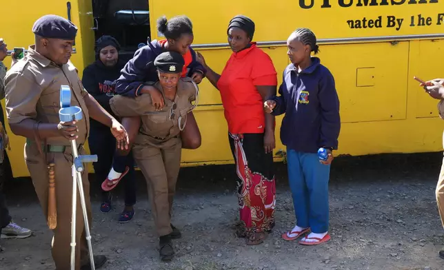 An injured student is evacuated following an early morning fire outbreak at Utumishi Girls School in the Gilgil area, central Kenya, Thursday, May 28, 2026. (AP Photo/Andrew Kasuku)