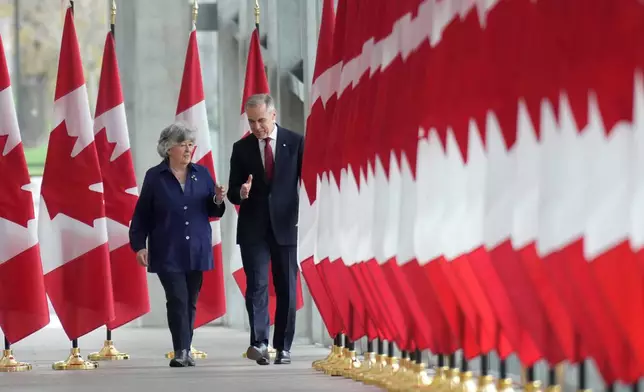 Canada Prime Minister Mark Carney walks with Louise Arbour to announce the new governor general during an event in Ottawa, Tuesday, May 5 2026. (Adrian Wyld/The Canadian Press via AP)