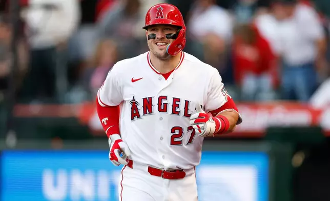 Los Angeles Angels' Mike Trout runs back to the dugout after hitting a two-run home run during the first inning of a baseball game against the Texas Rangers, Saturday, May 23, 2026, in Anaheim, Calif. (AP Photo/Caroline Brehman)