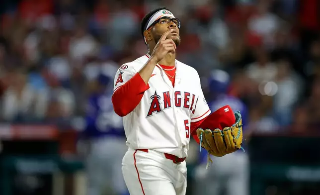 Los Angeles Angels starting pitcher Walbert Urena (57) reacts after stranding the bases loaded to end the fifth inning against the Texas Rangers, Saturday, May 23, 2026, in Anaheim, Calif. (AP Photo/Caroline Brehman)