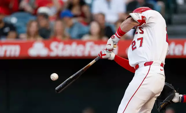 Los Angeles Angels' Mike Trout hits a two-run home run during the first inning of a baseball game against the Texas Rangers, Saturday, May 23, 2026, in Anaheim, Calif. (AP Photo/Caroline Brehman)