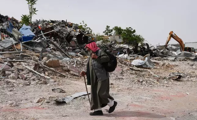 A man inspects the site of an Israeli army demolition campaign that targeted several Palestinian commercial structures overnight, days after the issue of demolition and evacuation orders to owners, in the West Bank town of Al-Eizariya Tuesday, May 12, 2026. (AP Photo/Mahmoud Illean)