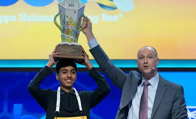 E.W. Scripps Company president and CEO Adam Symson, right, holds the trophy over winner of the 2026 Scripps National Spelling Bee, Shrey Parikh, 14, of Rancho Cucamonga, Calif., at DAR Constitution Hall, Thursday, May 28, 2026, in Washington. (AP Photo/Jose Luis Magana)
