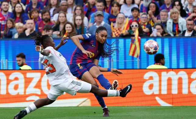 Bayern's Bernadette Kakounan, left, tries to block a cross from Barcelona's Salma Paralluelo during the women's Champions League semifinal soccer match between FC Barcelona and FC Bayern Munich in Barcelona, Spain, Sunday, May 3, 2026. (AP Photo/Joan Monfort)