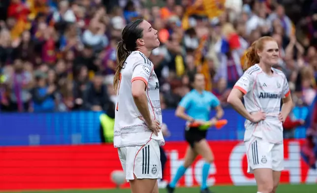 Bayern's Vanessa Gilles and Stine Ballisager, right, react at the end of the women's Champions League semifinal soccer match between FC Barcelona and FC Bayern Munich in Barcelona, Spain, Sunday, May 3, 2026. (AP Photo/Joan Monfort)