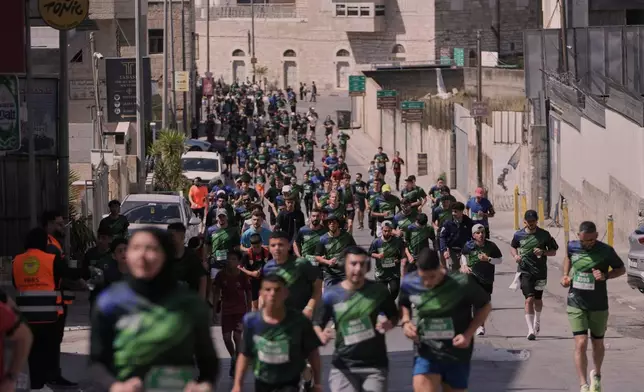 Runners participate in the Palestine Marathon in the West Bank city of Bethlehem, Friday, May 8, 2026. (AP Photo/Mahmoud Illean)