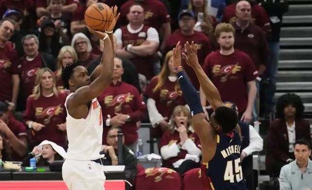 New York Knicks forward Og Anunoby (8) shoots against Cleveland Cavaliers guard Donovan Mitchell (45) during the first half of Game 3 in the Eastern Conference finals NBA basketball playoffs series Cleveland, Monday, May 24, 2027. (AP Photo/Sue Ogrocki)