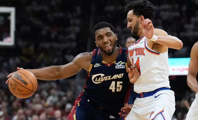 Cleveland Cavaliers guard Donovan Mitchell (45) controls the ball against New York Knicks guard Landry Shamet (44) during the second half of Game 3 in the Eastern Conference finals NBA basketball playoffs series in Cleveland, Monday, May 24, 2027. (AP Photo/Sue Ogrocki)