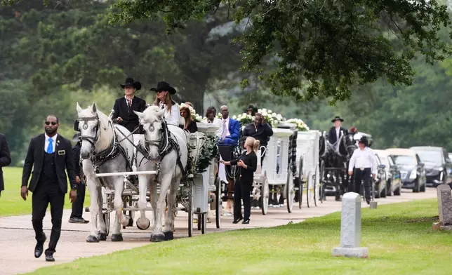 Caissons carry the caskets of eight children who were killed during a mass shooting last month, Saturday, May 9, 2026, at Forest Park Cemetery West in Shreveport, La. (AP Photo/Gerald Herbert)