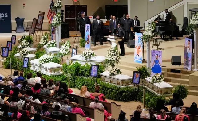 People listen during funeral services for the eight children who were killed during a mass shooting last month, Saturday, May 9, 2026, at the Summer Grove Baptist Church in Shreveport, La. (AP Photo/Gerald Herbert)