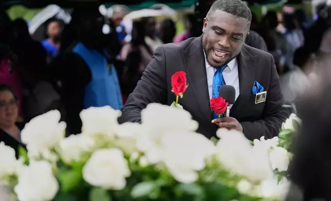 Roses are placed on caskets during the burial of the eight children who were killed during a mass shooting last month, Saturday, May 9, 2026, at Forest Park Cemetery West in Shreveport, La. (AP Photo/Gerald Herbert)