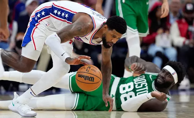 Philadelphia 76ers' Paul George, left, chases a loose ball past Boston Celtics' Neemias Queta during the second half of Game 6 in a first-round NBA basketball playoff series Thursday, April 30, 2026, in Philadelphia. (AP Photo/Matt Slocum)