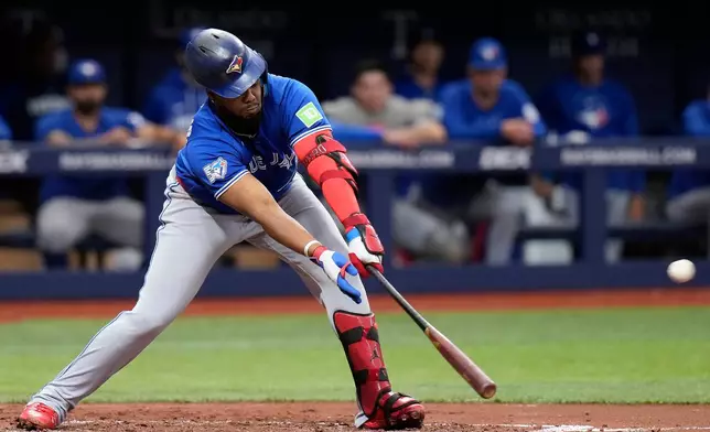 Toronto Blue Jays' Vladimir Guerrero Jr. connects for an RBI single off Tampa Bay Rays pitcher Nick Martinez during the third inning of a baseball game Monday, May 4, 2026, in St. Petersburg, Fla. (AP Photo/Chris O'Meara)