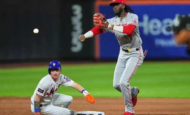 Cincinnati Reds' Elly de la Cruz, right, throws out New York Mets' Mark Vientos at first base after forcing out A.J. Ewing for a double play during the sixth inning of a baseball game Tuesday, May 26, 2026, in New York. (AP Photo/Frank Franklin II)