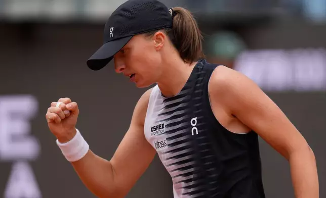 Iga Swiatek, of Poland, celebrates after wining a point during the quarter-final match against Jessica Pegula, of the United States, at the Italian Open tennis tournament in Rome, Wednesday, May 13, 2026. (AP Photo/Gregorio Borgia)