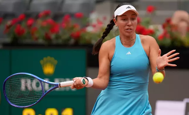 Jessica Pegula, of the United States, returns the ball to Iga Swiatek, of Poland, during their quarter-final match at the Italian Open tennis tournament in Rome, Wednesday, May 13, 2026. (AP Photo/Gregorio Borgia)