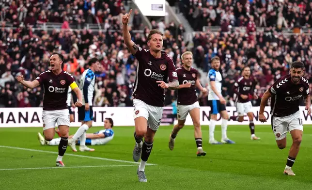 Heart of Midlothian's Frankie Kent, center, celebrates scoring their first goal of the game during the Scottish Premiership soccer match between Heart of Midlothian and Falkirk, Wednesday, May 13, 2026, in Edinburgh, Scotland. (Andrew Milligan/PA via AP)