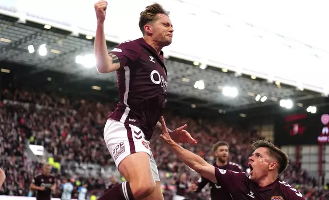 Heart of Midlothian's Frankie Kent, left, celebrates scoring their first goal of the game during the Scottish Premiership soccer match between Heart of Midlothian and Falkirk, Wednesday, May 13, 2026, in Edinburgh, Scotland. (Andrew Milligan/PA via AP)